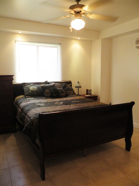 Bedroom with queen size bed and window