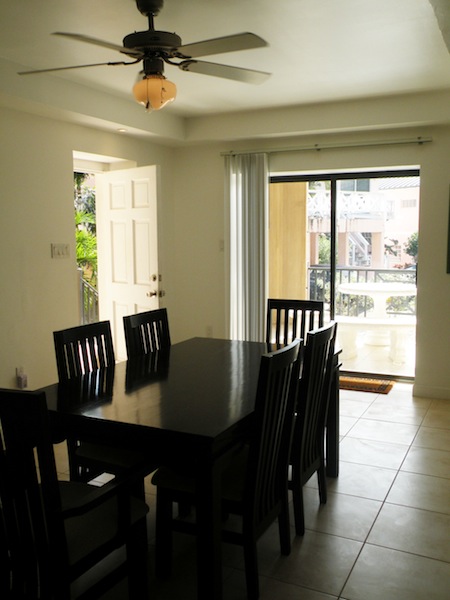 Dining room with dark furniture and balcony in background