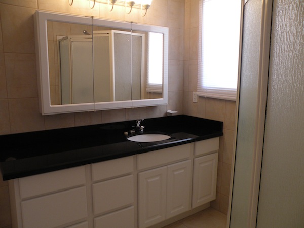 Large bathroom with granite counter and storage cabinet