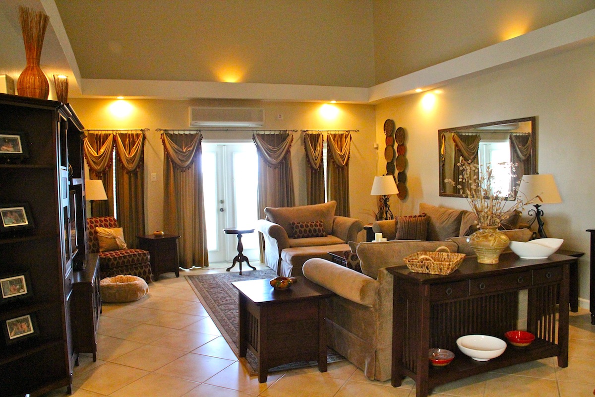 Elengantly furnished living room with cathedral ceiling